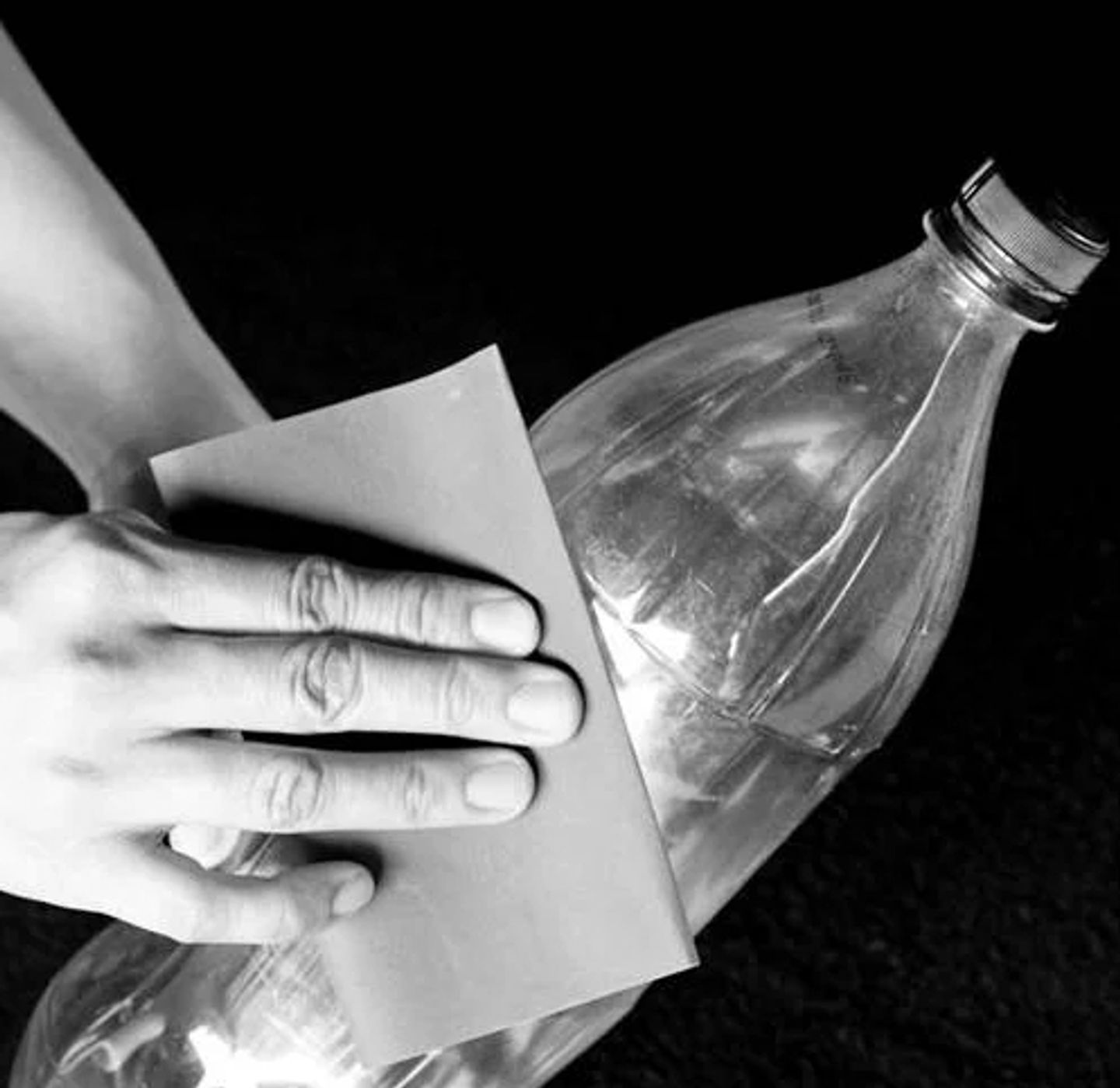 Scratching the surface of the PET bottle with sandpaper